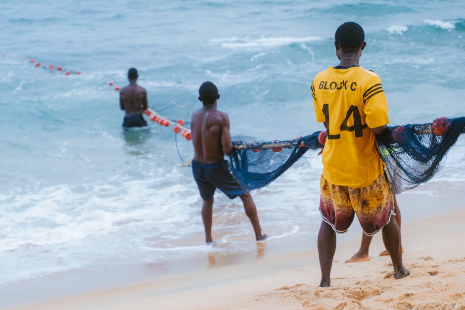 Fishermen working together on the beach symbolizing community strength