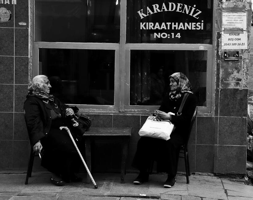 Two women sitting and talking outside representing social wellness